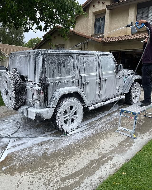 A vehicle being washed with foam