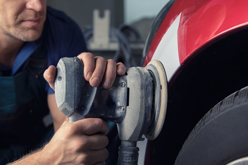 A detailer polishing a car to a high gloss finish